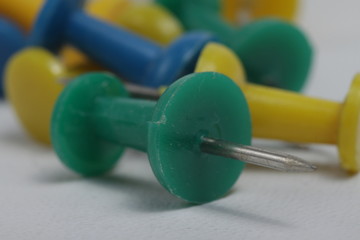 Colored thumb tack on a white background