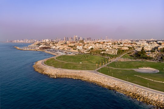 Tel Aviv skyline off the shore of the Mediterranean sea - Aerial photo. View from Midron Yaffo Park for Old Jaffa and Tel aviv in background.