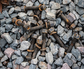 Old rusty screws on the ground