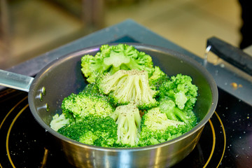 Broccoli is fried with butter or boiled in a pan.
