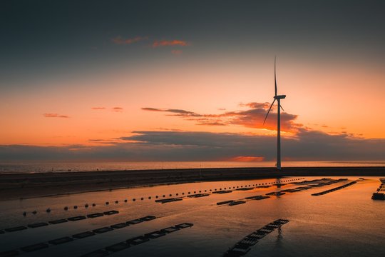 Reflection Of A Turbine On Wet Ground At Sunset In Neeltje Jans, Netherlands