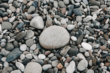 Gravel pattern of colored stones. Abstract nature pebbles background. Stone background. Sea peblles beach. Top view.