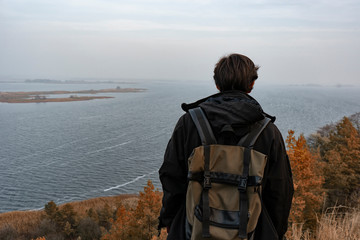 A man stands on a cliff, a sense of freedom