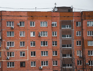 Multi-storey panel house, old. Houses of the USSR, roof, stairs, communications. Black and white vintage photo.