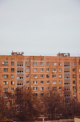Multi-storey panel house, old. Houses of the USSR, roof, stairs, communications. Black and white vintage photo.