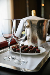 glass of wine and bottle of red wine on wooden table