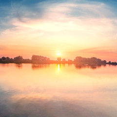 Fototapeta premium Beautiful sunset, sky with clouds above lake.