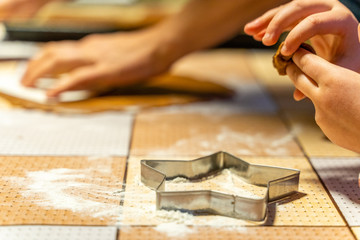 Kid preparing dough for gingerbread cookies - closeup photo, isolated action