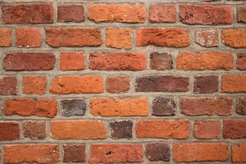 Background, bright red brick wall of an old building. Brick textured masonry