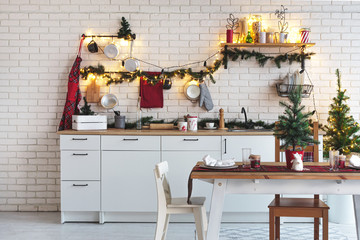 Interior white kitchen with lights and red christmas decorations