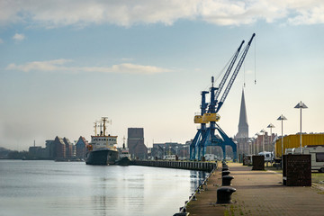 Fototapeta na wymiar cranes in port of rostock - beautiful sunlight