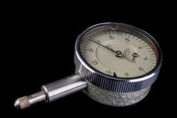 Analog sensor for accurate measurements on a dark workbench. A tool for precise measurement in the workshop.
