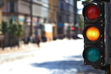  Traffic light  on the crossroad. Yellow light. - Powered by Adobe