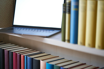 Close up of computer in bookcase