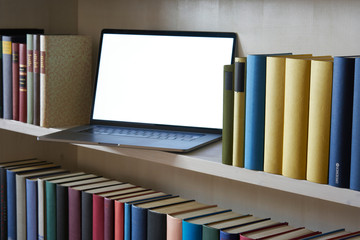 Close up of laptop in bookcase