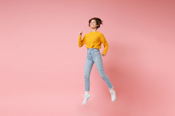 Funny young brunette woman girl in yellow sweater posing isolated on pastel pink background in...