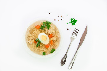 Top view russian meat jelly. Ukrainian home made food on a white dish with, egg, parsley, fork and knife, silverware isolated on white. Slavic cuisine concept