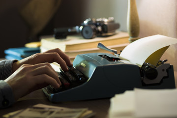 Workplace of a writer, journalist, creator. Old typewriter and documents on the table. Retro style.