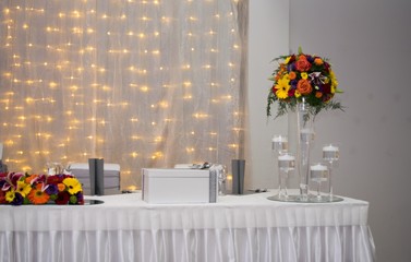 Decor with flowers on wedding table of newlyweds