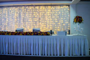 Decor with flowers on wedding table of newlyweds