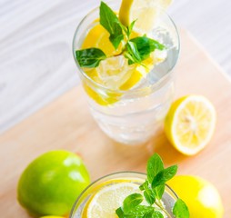 Glasss of mojito with lemon and drinking straw