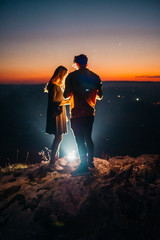 a couple above night city