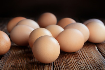 set of raw chicken eggs on wooden table