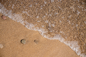 Fototapeta na wymiar Beach macro with pebble and tide coming in