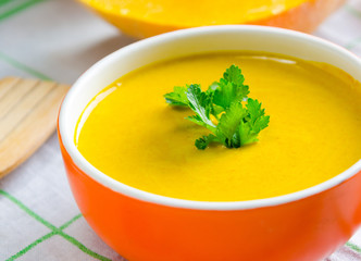 Pumpkin soup served on the table in bowl