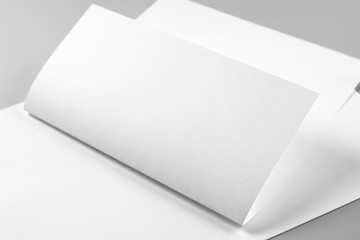 Blank Folded Letterhead or Flyer over Stack of Letterheads