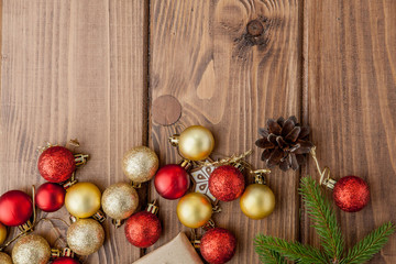 Fototapeta na wymiar Christmas background with New year toys and fir tree branch on wooden table