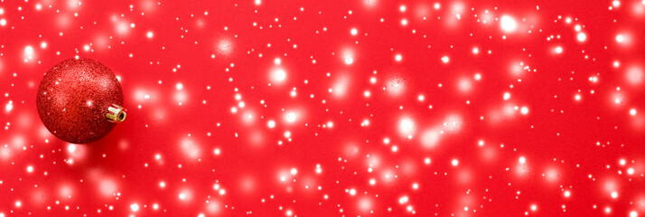 Christmas baubles on red background with snow glitter, luxury winter holiday card