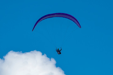 Paraglider flying in the clouds