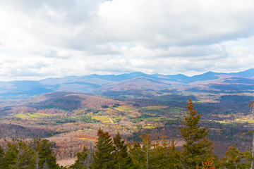 Mountainous landscape on a cloudy day in late autumn. Autumn panorama in vicinity of Stowe, Vermont, USA.