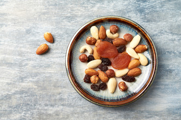 Nuts, raisins and apricots on rustic wooden background. Concept for healthy snack. Top view. Copy space. 
