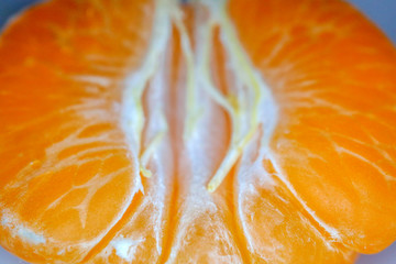 Mandarin peeled and slices on the background of macro