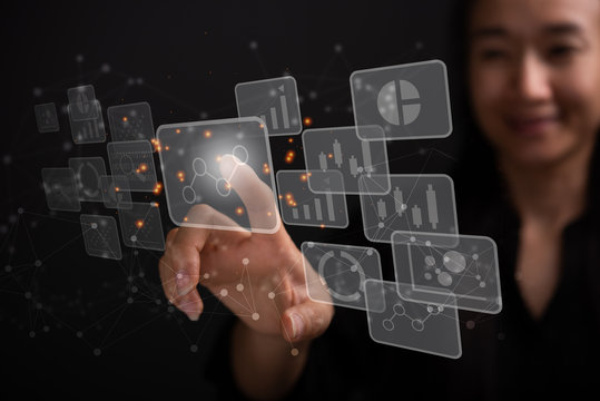 big data analytics and business intelligence concept with chart and graph icons on a digital screen interface and a businesswoman in background