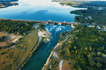 Aerial view of Dam at reservoir with flowing water, hydroelectricity power station, drone photo.