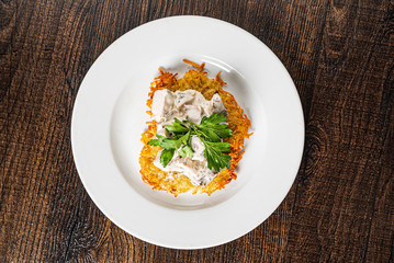 potato pancakes with mushrooms and sauce