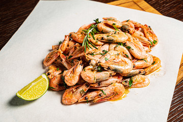 shrimps with lime dressing on the wooden background