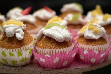 colorful cupcakes with cream and kiwi