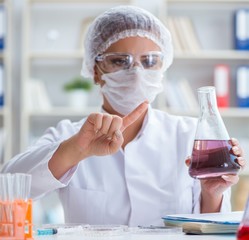 Female scientist researcher conducting an experiment in a labora