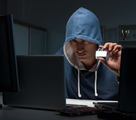 Hacker hacking computer at night