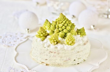 crep cake for Christmas and New Year.  Christmas tree decorations cabbage romanesco. Snack cake with salmon, avocado and soft cheese. Grains of cottage cheese play the role of snowdrifts.