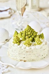 crep cake for Christmas and New Year.  Christmas tree decorations cabbage romanesco. Snack cake with salmon, avocado and soft cheese. Grains of cottage cheese play the role of snowdrifts.