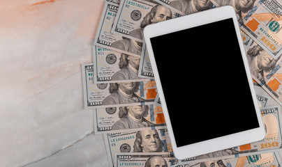 Dollar bills and digital devices tablet with technology and money