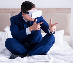 Businessman wearing a virtual reality headset in the bedroom