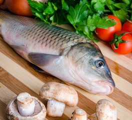 The uncooked fish on cutting board in meal preparation concept