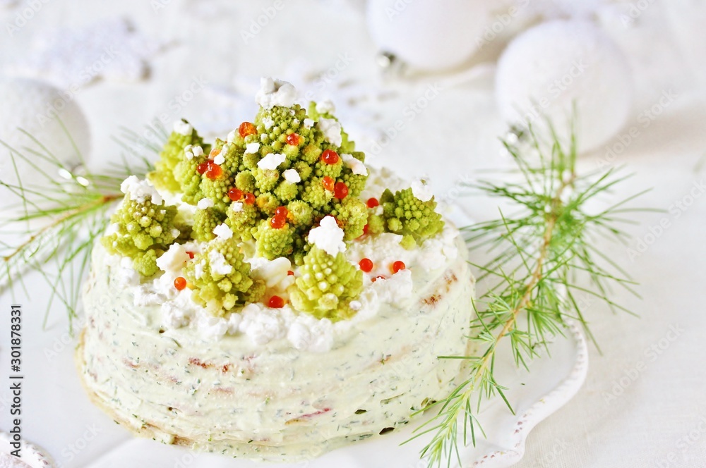 Wall mural crep cake for Christmas and New Year.  Christmas tree decorations cabbage romanesco. Snack cake with salmon, avocado and soft cheese. Grains of cottage cheese play the role of snowdrifts.