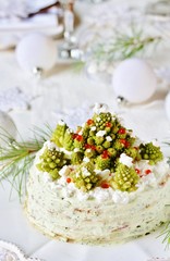 crep cake for Christmas and New Year.  Christmas tree decorations cabbage romanesco. Snack cake with salmon, avocado and soft cheese. Grains of cottage cheese play the role of snowdrifts.